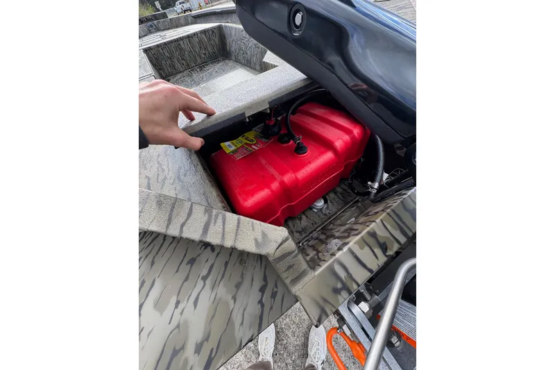 Slide: The Image of 2026 SeaArk 1752 Slayer X Pro boat with red fuel tank compartment open. - 18