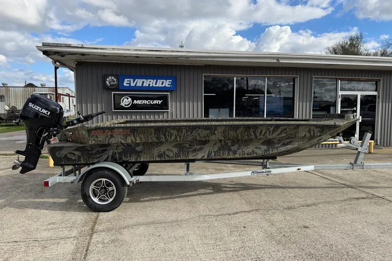 Slide: The Image of 2026 SeaArk 1752 Slayer X Pro boat on trailer, parked outside dealership. - 3