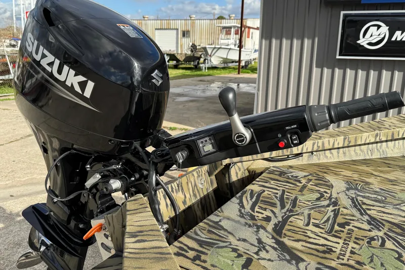 Slide: The Image of 2026 SeaArk 1752 Slayer X Pro with Suzuki outboard motor and camouflage interior design. - 9