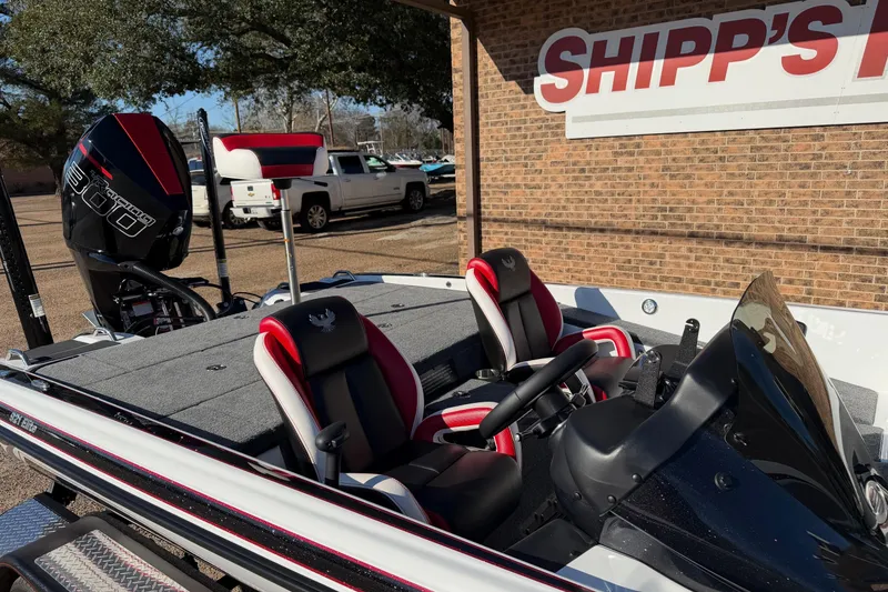 Slide: The Image of 2024 Phoenix 921 Elite II boat with dual seats and powerful engine, parked outdoors. - 4