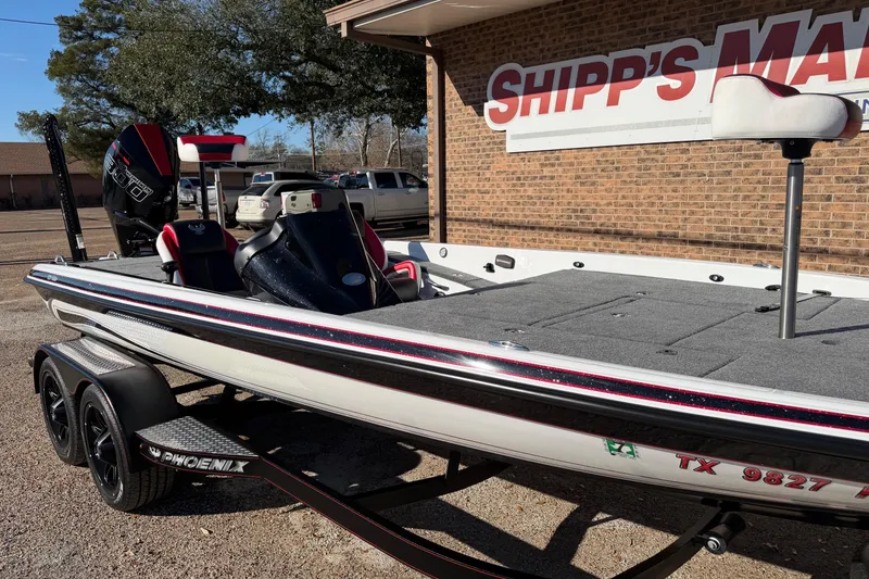 Slide: The Image of 2024 Phoenix 921 Elite II boat parked outside Shipp's Marine, featuring sleek design and dual axle trailer. - 5
