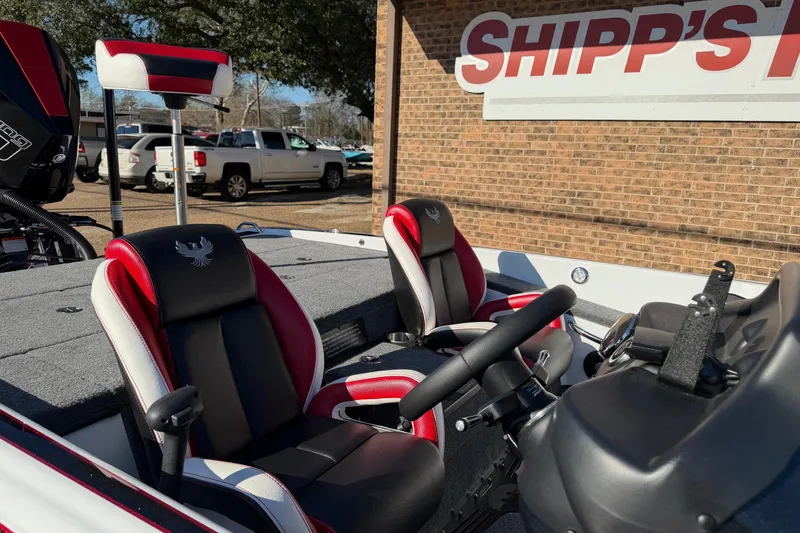 Slide: The Image of 2024 Phoenix 921 Elite II boat interior with red and black seats at Shipp's location. - 7