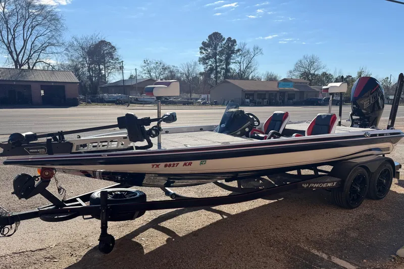 Slide: The Image of 2024 Phoenix 921 Elite II boat on trailer, parked outdoors under clear sky. - 8