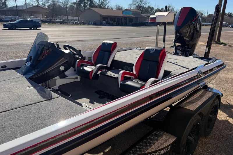 Slide: The Image of 2024 Phoenix 921 Elite II boat with dual seats and powerful engine, parked roadside. - 9