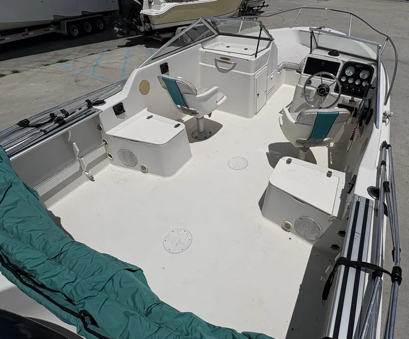 Slide: The Image of 1996 Pro-Line 202 boat interior with seating and steering console. - 10