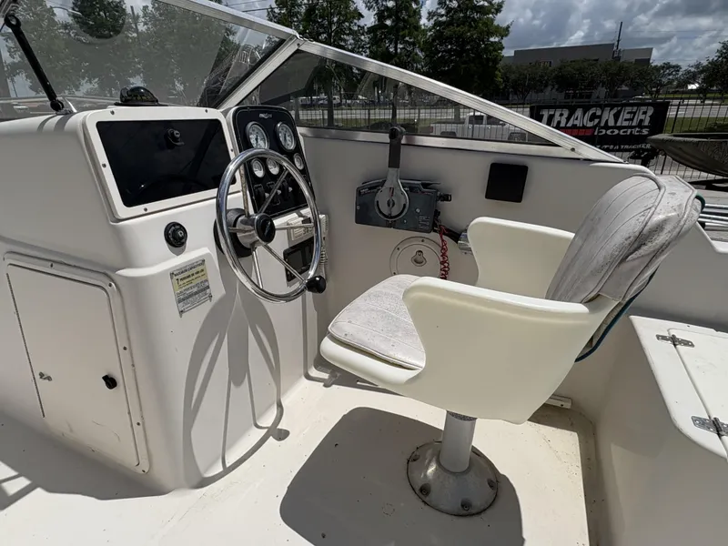 Slide: The Image of 1996 Pro-Line 202 boat cockpit with steering wheel and captain's chair. - 11