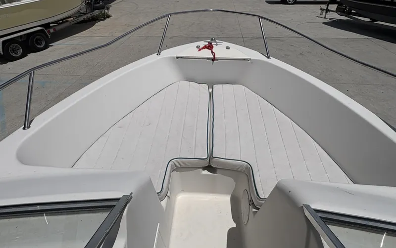 Slide: The Image of 1996 Pro-Line 202 boat interior with cushioned seating and railing. - 7