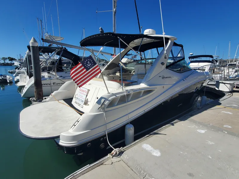 The Image of 2008 Sea Ray 310 Sundancer docked with American flag. - 0