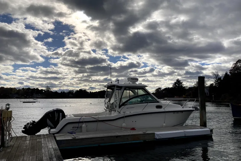 The Image of 2014 Boston Whaler 285 Conquest docked under dramatic cloudy sky. - 0