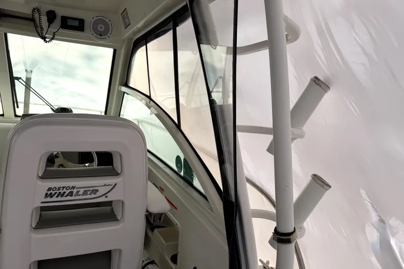 Slide: The Image of Interior view of 2014 Boston Whaler 285 Conquest boat, featuring helm and seating. - 10