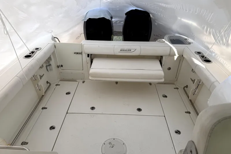 Slide: The Image of 2014 Boston Whaler 285 Conquest boat interior with seating and storage compartments. - 11