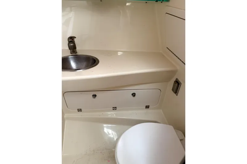 Slide: The Image of 2014 Boston Whaler 285 Conquest bathroom with sink and toilet. - 21