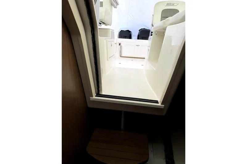 Slide: The Image of 2014 Boston Whaler 285 Conquest interior view, showcasing cabin entrance and seating area. - 23