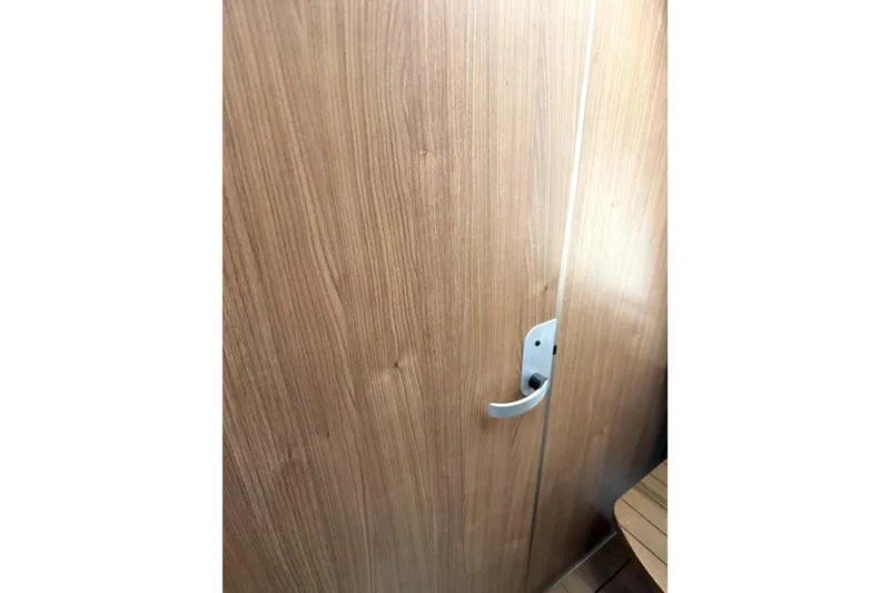 Slide: The Image of Wooden cabin door with handle inside 2014 Boston Whaler 285 Conquest boat. - 24