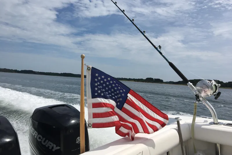 Slide: The Image of Boston Whaler 285 Conquest 2014 with US flag and fishing rod at sea. - 3