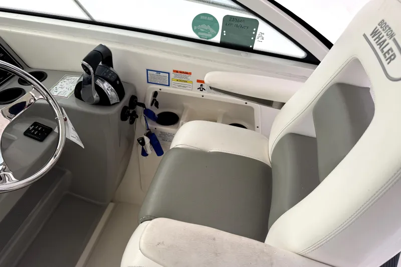 Slide: The Image of 2014 Boston Whaler 285 Conquest helm with steering wheel and control panel. - 6