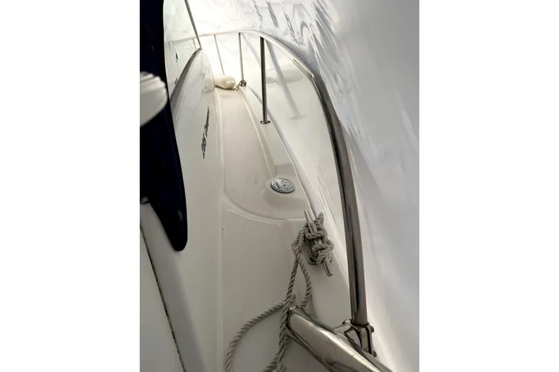Slide: The Image of 2014 Boston Whaler 285 Conquest boat deck with railing and rope detail. - 7