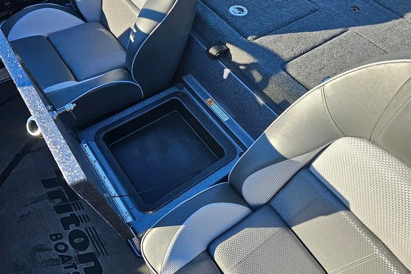 Slide: The Image of Interior of 2026 Triton 20XP Patriot boat showing foot pedal and warning labels. - 13
