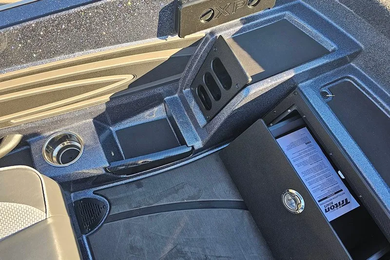 Slide: The Image of Open storage compartments in a 2026 Triton 20XP Patriot boat. - 18
