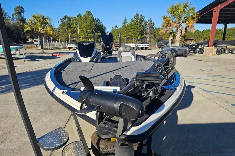 Slide: The Image of 2026 Triton 20XP Patriot boat on trailer, featuring Lowrance equipment, parked outdoors. - 4