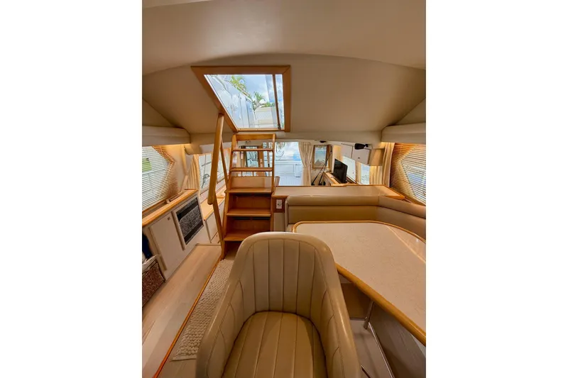 Slide: The Image of Captain's chair and Dinette; looking aft to Flybridge access stairway - 12