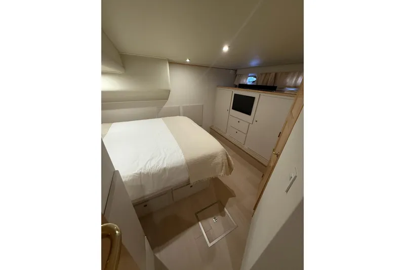 Slide: The Image of Master Stateroom with hanging locker, TV, and storage - 32