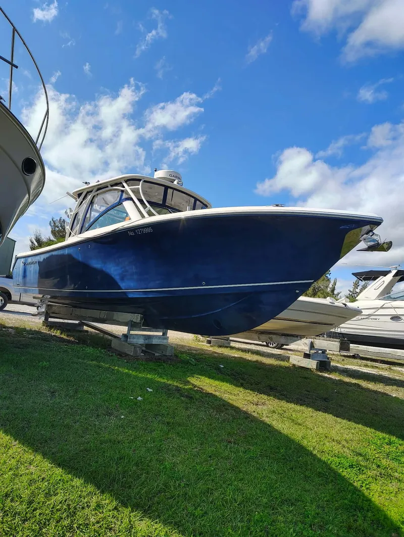 The Image of 2017 Sailfish 325 Dual Console boat displayed on grass. - 0