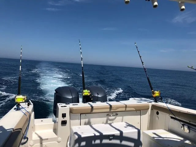 Slide: The Image of Sailfish 325 Dual Console 2017 on open sea with fishing rods. - 8