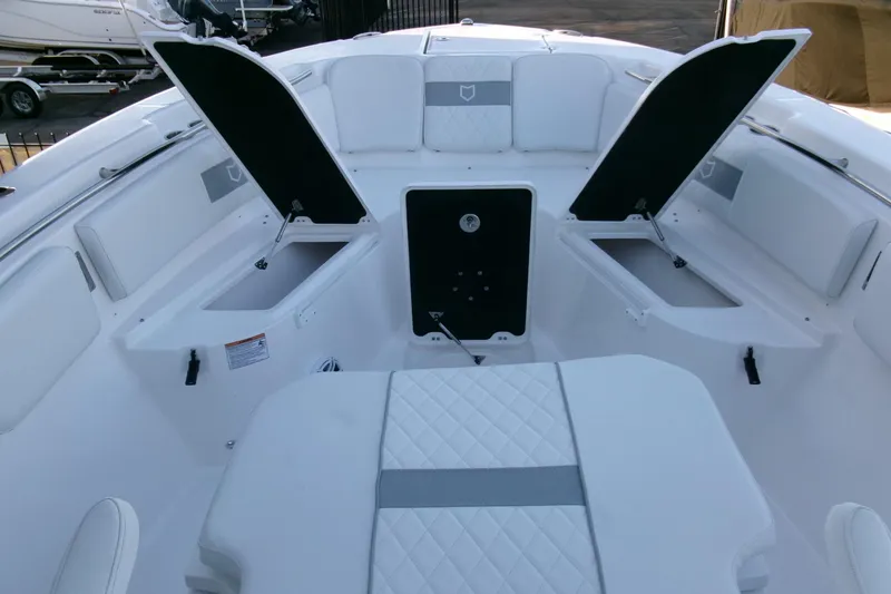 Slide: The Image of 2026 Sea Fox 288 Commander boat interior with open storage compartments and cushioned seating. - 12