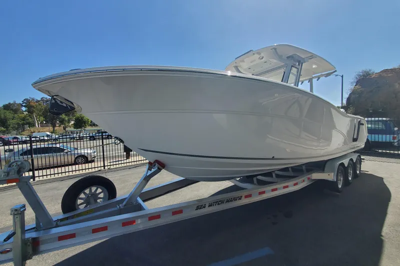 Slide: The Image of 2026 Sea Fox 288 Commander boat on trailer in sunny outdoor setting. - 2