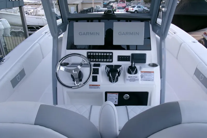 Slide: The Image of 2026 Sea Fox 288 Commander boat dashboard with Garmin displays and steering wheel. - 21