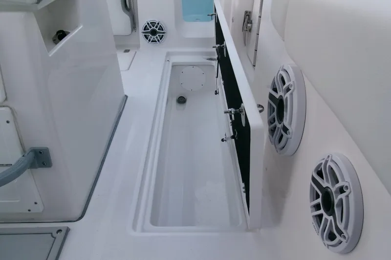 Slide: The Image of 2026 Sea Fox 288 Commander interior with storage compartment and speakers. - 36