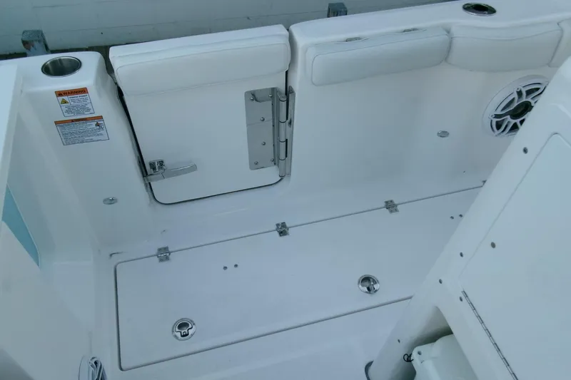 Slide: The Image of 2026 Sea Fox 288 Commander boat interior, featuring white seating and storage compartments. - 43