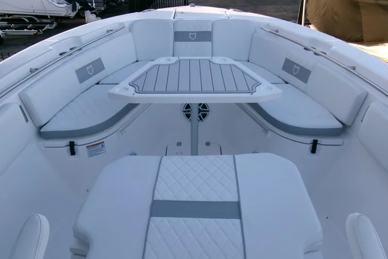 Slide: The Image of 2026 Sea Fox 288 Commander boat interior with cushioned seating and table. - 8