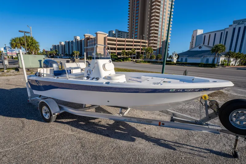 The Image of 2011 NauticStar 1910 NauticBay boat on trailer, urban background, clear sky. - 0