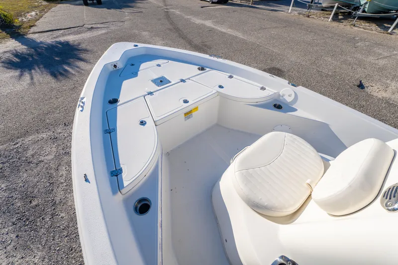 Slide: The Image of 2011 NauticStar 1910 NauticBay boat interior with white seating and storage compartments. - 18