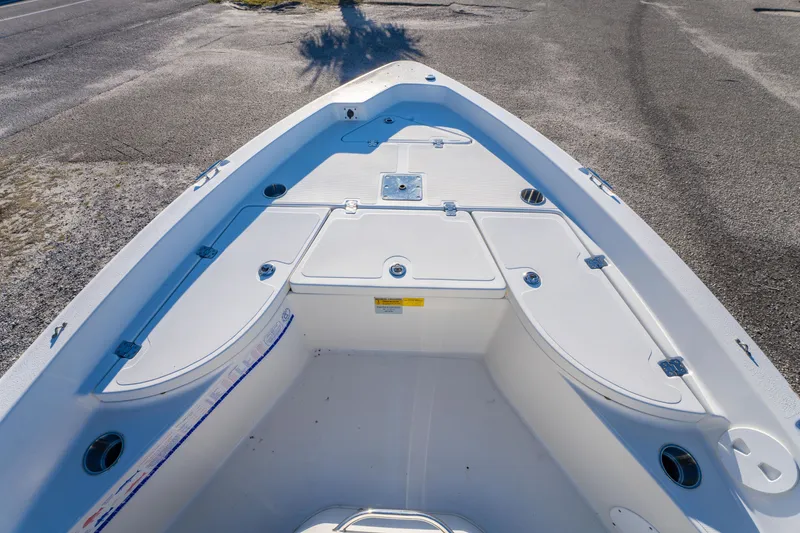 Slide: The Image of 2011 NauticStar 1910 NauticBay boat interior with white seating and storage compartments. - 19