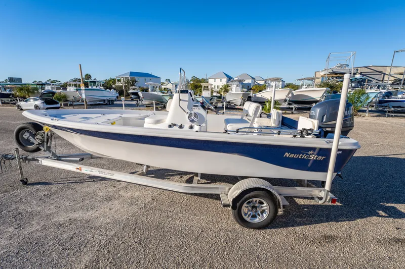 Slide: The Image of 2011 NauticStar 1910 NauticBay boat on trailer in marina setting. - 2
