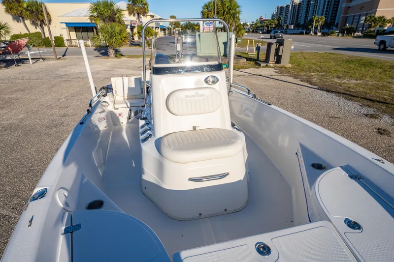 Slide: The Image of 2011 NauticStar 1910 NauticBay boat interior, featuring storage compartments and clean deck design. - 20
