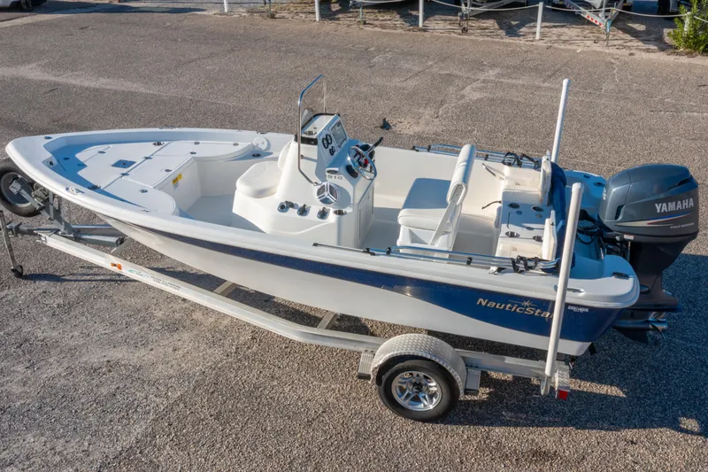 Slide: The Image of 2011 NauticStar 1910 NauticBay boat on trailer, parked near a road. - 23