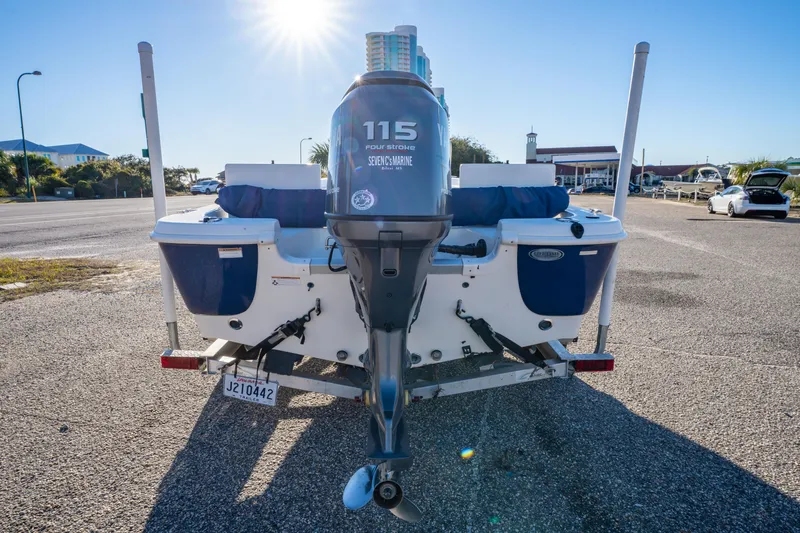 Slide: The Image of 2011 NauticStar 1910 NauticBay boat with Yamaha engine on trailer, parked near hotel. - 28