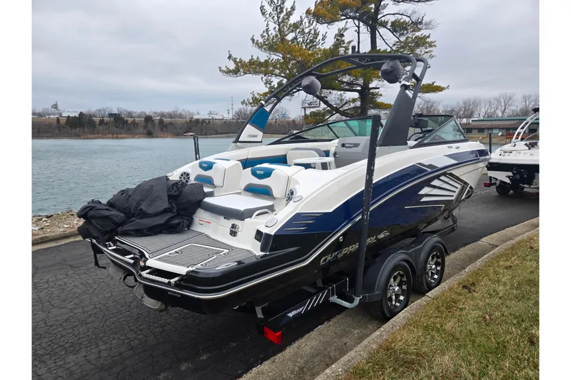 Slide: The Image of 2016 Chaparral Vortex 243 VRX boat on trailer by a lakeside. - 1