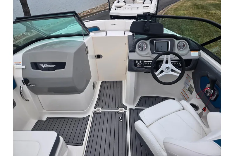 Slide: The Image of 2016 Chaparral Vortex 243 VRX boat interior with steering wheel and dashboard controls. - 11