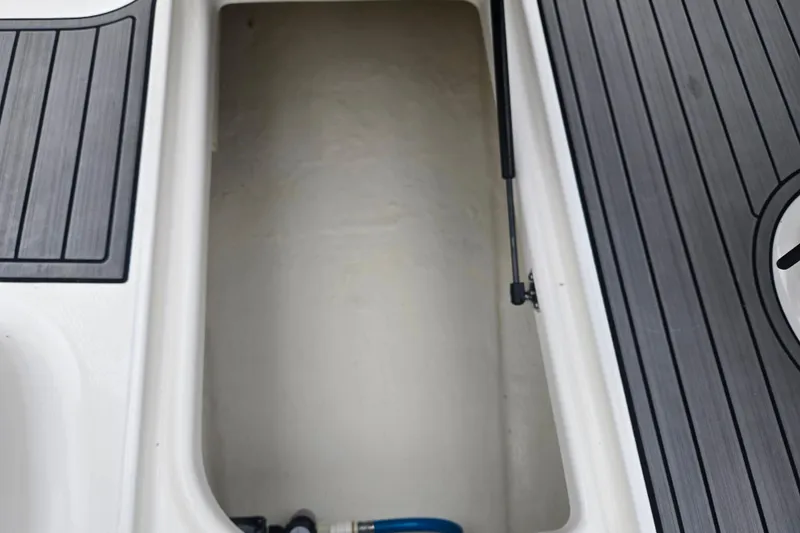 Slide: The Image of Storage compartment of 2016 Chaparral Vortex 243 VRX boat with sleek flooring. - 16