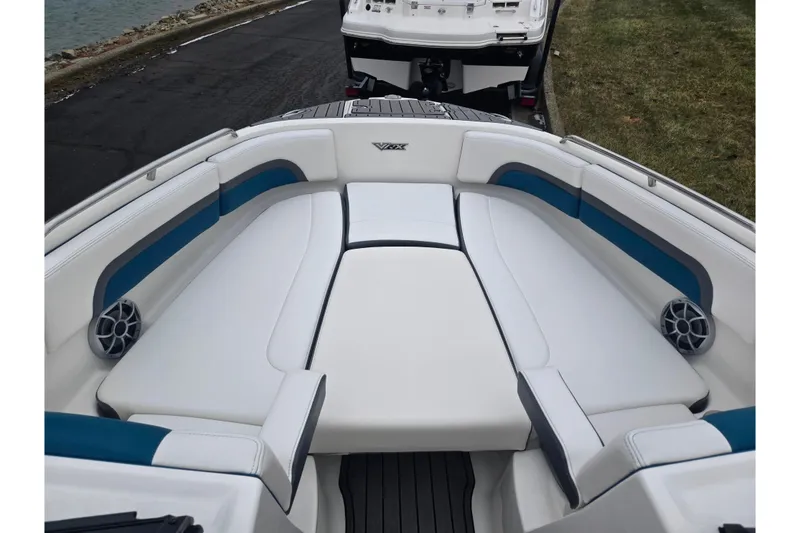 Slide: The Image of 2016 Chaparral Vortex 243 VRX boat interior with white and blue seating. - 18