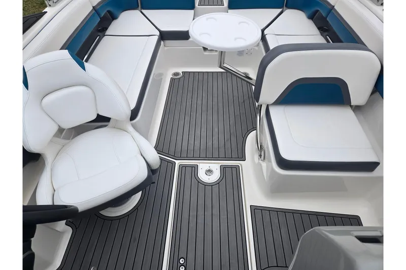 Slide: The Image of 2016 Chaparral Vortex 243 VRX boat interior with white seating and gray flooring. - 22
