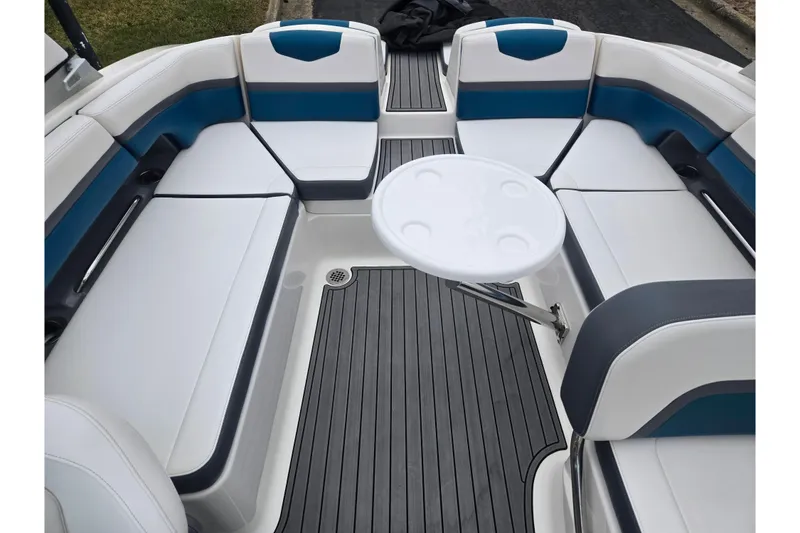 Slide: The Image of 2016 Chaparral Vortex 243 VRX boat interior with white and blue seating, round table. - 23