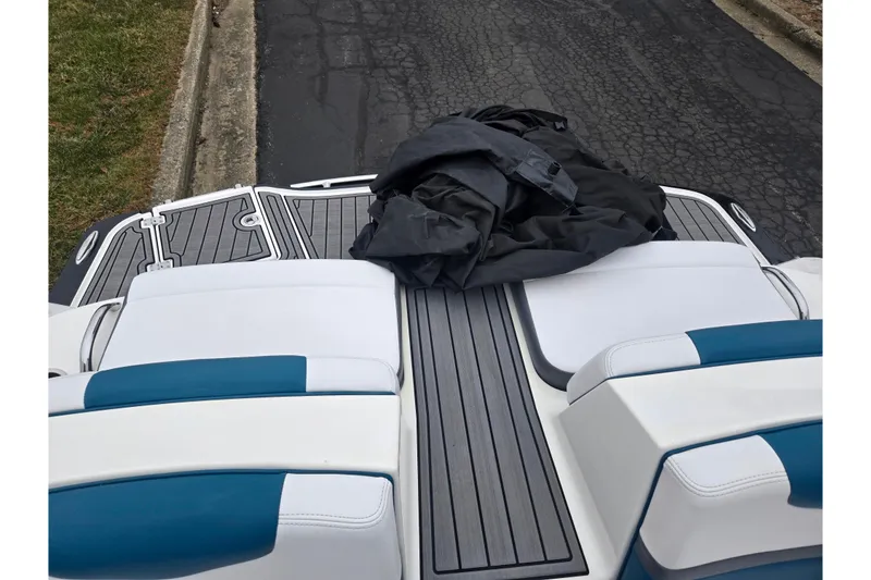 Slide: The Image of 2016 Chaparral Vortex 243 VRX boat interior with blue and white seating. - 25