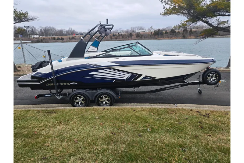 Slide: The Image of 2016 Chaparral Vortex 243 VRX boat on trailer by a lakeside road. - 9