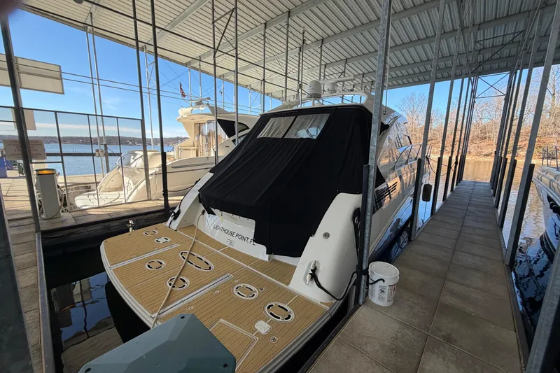 Slide: The Image of 2014 Sea Ray 540 Sundancer yacht docked in a marina under a covered structure. - 10